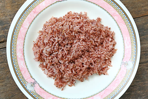 istock Thai brown rice in dish against wood texture 610121334