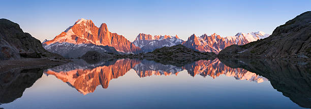 istock Panorama of Alps mountain with sunset light reflecting in lake 610121952