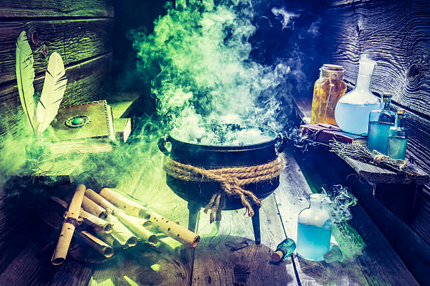 istock Magical witcher cauldron with books, scrolls and potions for Halloween 610122908