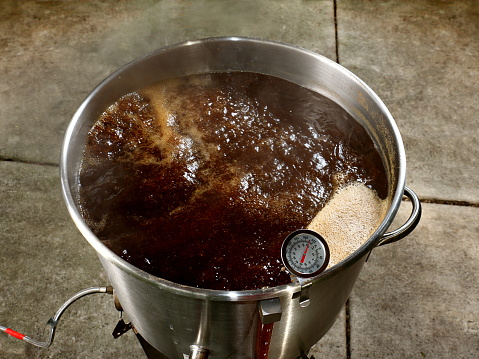 This image show wort being transferred from the boiler into a fermenter.  Pictured here is a brown ale that will ferment for two to three weeks before it’s ready to drink.