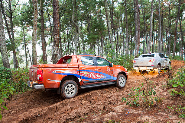 Chevrolet Colorado and Mazda BT-50 pick-up cars Mocchau, Vietnam - Jan 9, 2015: Chevrolet Colorado and Mazda BT-50 pick-up cars running on mud road in test drive in Vietnam. Chevrolet stock pictures, royalty-free photos & images