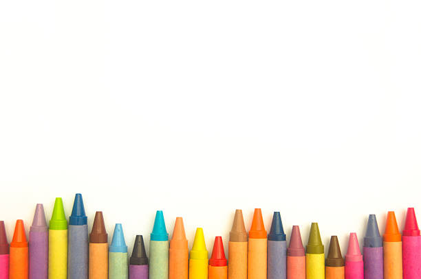 istock Colorful crayons in an irregular row on white background 610123582