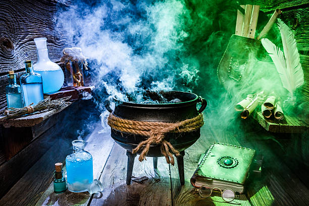 istock Old witcher cauldron with scrolls, books and potions for Halloween 610123884