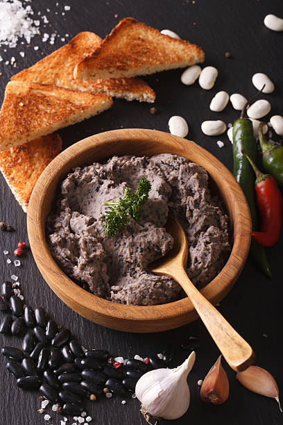 istock Frijoles refritos with ingredients close-up. Vertical 610125262