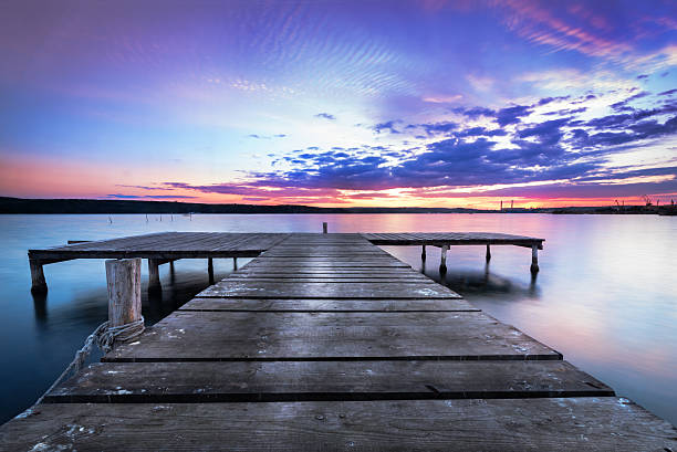 istock Wooden pier on a blue lake sunset. 610125920
