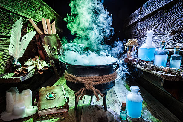 istock Mysterious witcher cauldron with blue potions and books 610127742