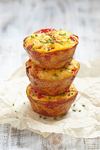 Delicious egg muffins Delicious egg muffins with ham, cheese and vegetables frittata stock pictures, royalty-free photos & images