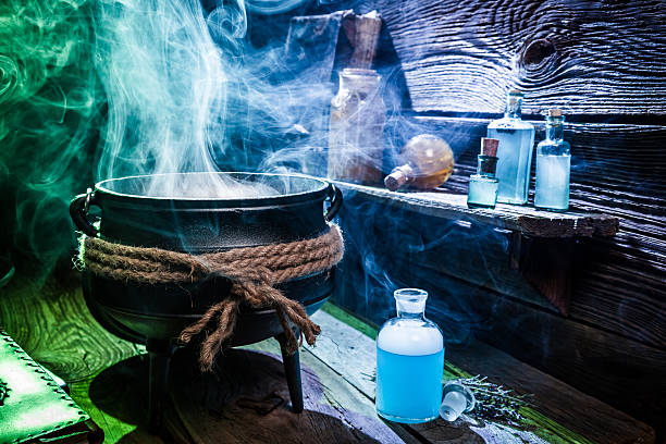istock Vintage witcher cauldron with blue potions for Halloween 610129876