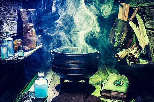 istock Magical witch pot with scrolls, books and blue potions 610131356