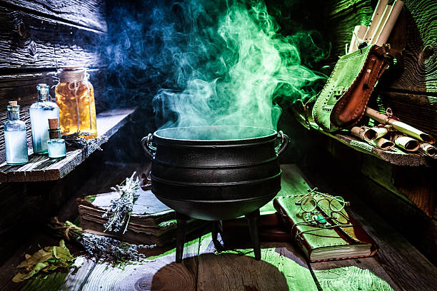 istock Witcher cauldron with blue potions and books for Halloween 610132200