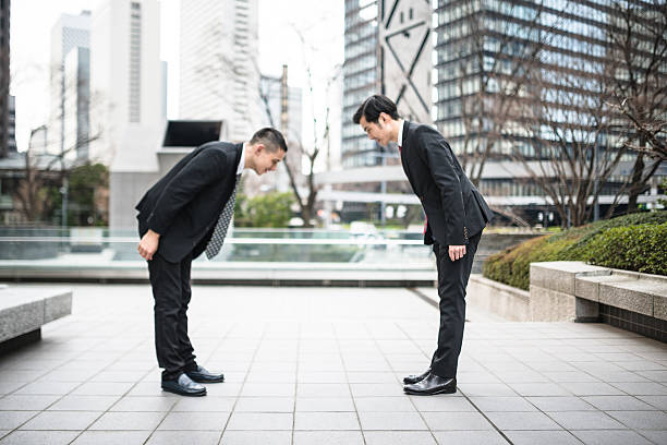 istock japanese Business greetings together on the downtown 610132380