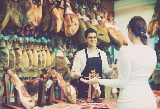 istock brunette choosing iberico and serrano jamon and smiling 610133298