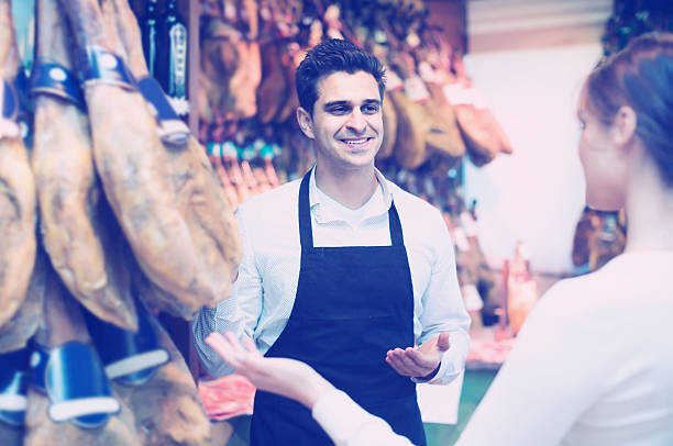 istock brunette choosing iberico and serrano jamon and smiling 610133376