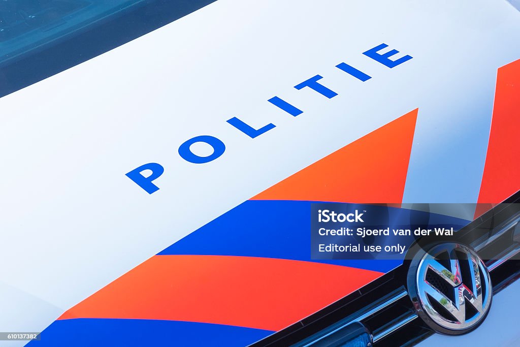 Police - Politie in Dutch on a police car front Kampen, The Netherlands - September 24, 2016: Dutch word for police - POLITIE - on the front of a Volkswagen Dutch police car with orange and blue stripes. Netherlands Stock Photo