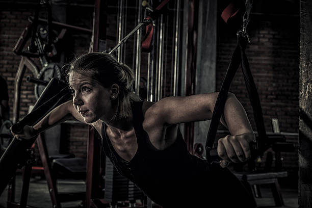 woman doing exercises in the gym close up woman doing exercises in the gym. Fitness and healthy lifestyle concept. blonde female bodybuilders stock pictures, royalty-free photos & images