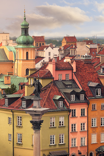 Townhouses and roofs of the old town of Warsaw, Poland. Sigismund's Column from 1644 on Castle Square can be seen in the foreground.