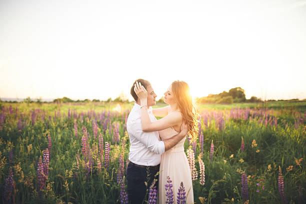 istock Emotional beautiful bride hugging newlywed groom from behind sunset at 610138574