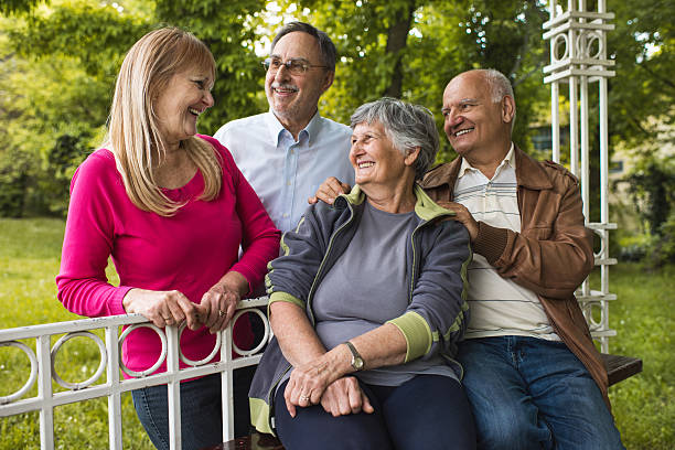 istock Group of two senior couples communicating in the park. 610139044