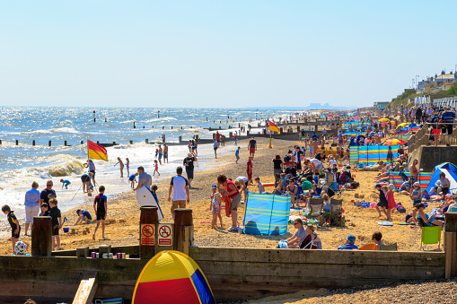 Southwold, UK - August 17, 2016 - People sunbathing and playing at Southwold beach.