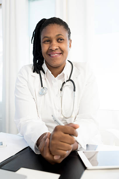 istock Female Doctor Sitting At Her Desk 610140890