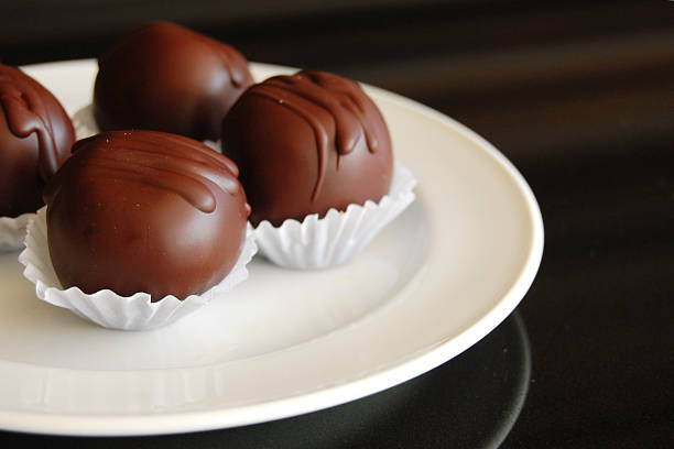 istock Assorted dark chocolate truffles with cocoa powder, 610142140