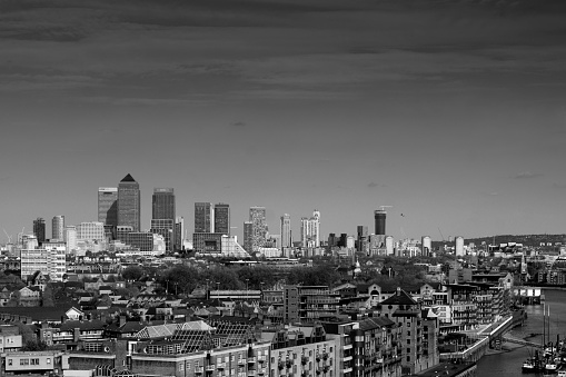 London, United Kingdom - May 1, 2016: Canary Wharf Skyline in the distance viewed over central London buildings in the foreground.
