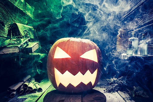istock Scary Halloween pumpkin with blue and green smoke 610144540