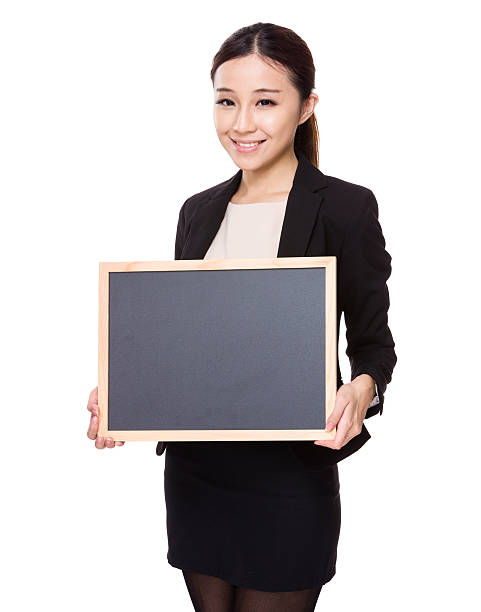 istock Businesswoman holding a chalkboard 610144910