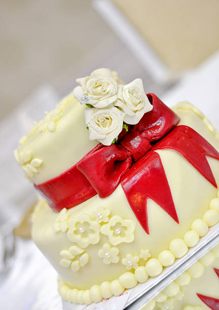 istock white Wedding Cake with red ribbons 610146554