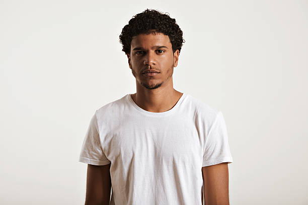 Attractive male model presenting blank white t-shirt stock photo