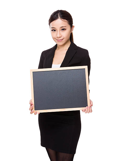 istock Businesswoman holding chalkboard 610147498