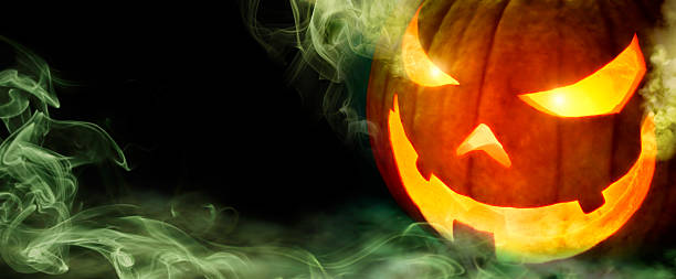 istock Jack o lantern with green smoke on black 610148052