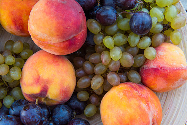 istock peaches and grapes in a plate on the table 610148452