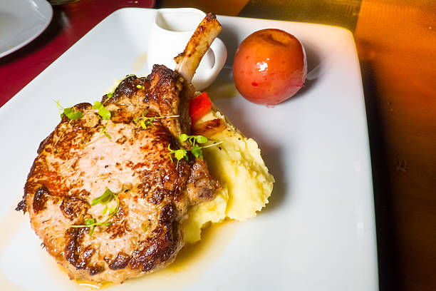 istock dish of lamb steak with apple and smash potato. 610151966