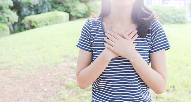 istock Woman holding her chest 610153480