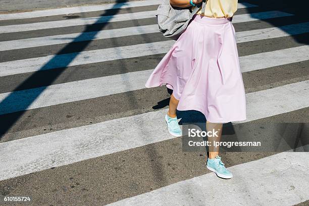 Girl In A Pink Skirt And Sneakers Crossing The Road Stock Photo - Download Image Now