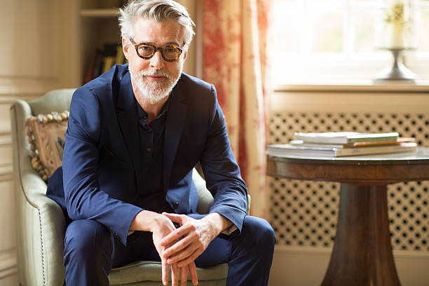 High class mature man portrait at home. High class mature man portrait at home. male meaning stock pictures, royalty-free photos & images