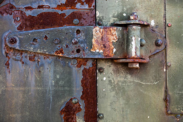 istock Old rusty metal hinge on the metal door 610157252