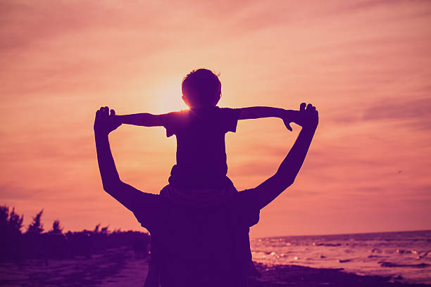 istock father and son having fun on sunset sky 610161076