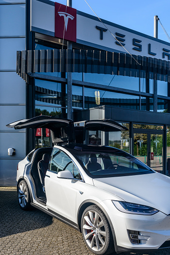 Duiven, The Netherlands - September 7, 2016: White Tesla Model X P90D all-electric crossover SUV at a Tesla dealership. The Tesla Model X is a full-sized all-electric crossover SUV made by Tesla Motors that uses falcon wing doors. 