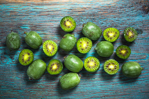 Kiwi berries on vibrant board stock photo