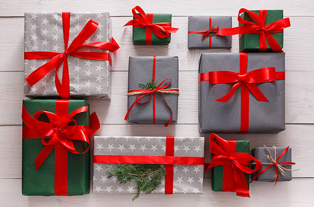 istock Top view of christmas present boxes on white wood background 610218688