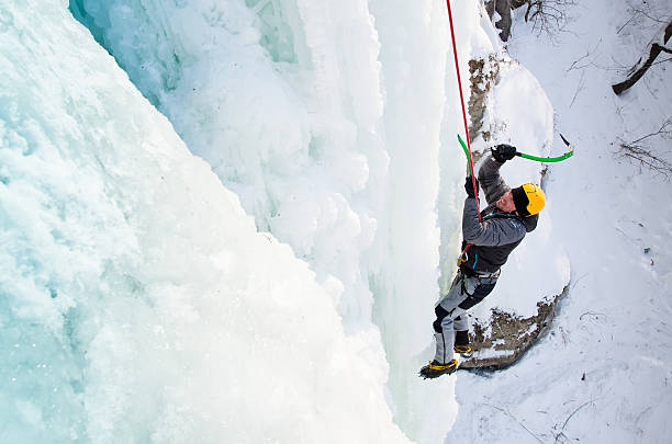 istock Man climbing frozen waterfall 610219526