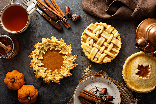 istock Homemade pumpkin pies decorated with fall leaves 610219582