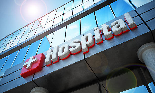 Hospital building exterior and hospital sign Fictitious hospital building exterior and hospital sign. Reflection of blue sky on the windows. entrance sign photos stock pictures, royalty-free photos & images