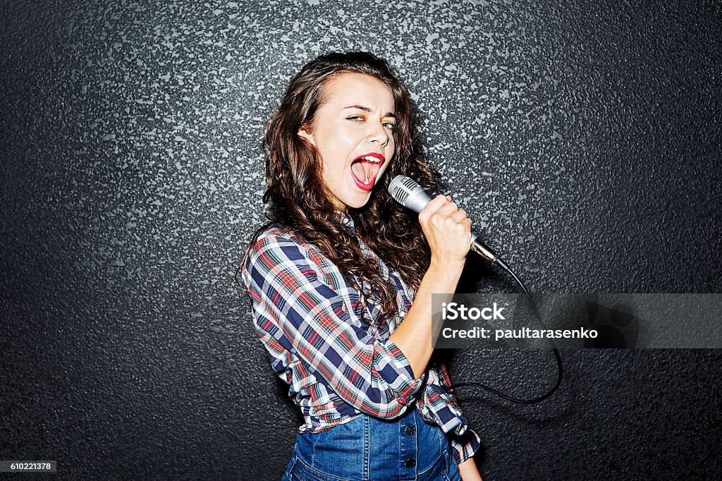 Woman singing with microphone Karaoke Stock Photo