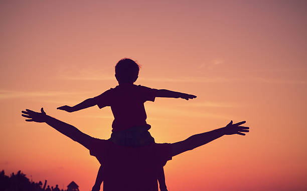 istock father and son having fun on sunset sky 610222584