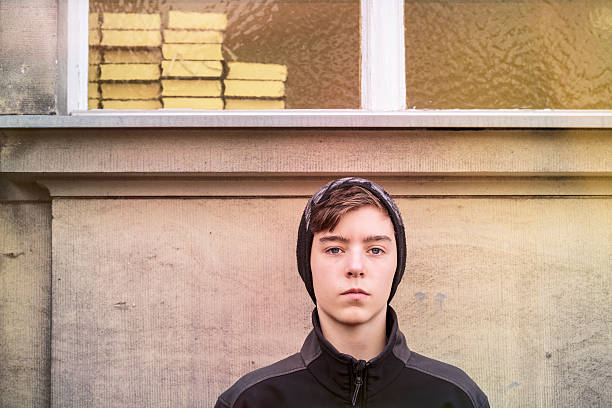 istock teenage boy with cap and books 610223276