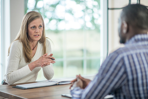 A business woman is interviewing a potential new employee in the office.