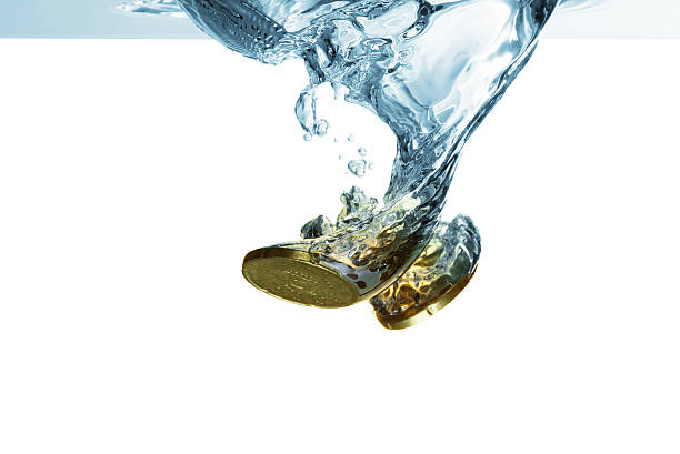 istock Euro coins falling in water with splash, isolated on white 610225292